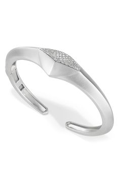 Round-cut diamonds add brilliant shine to a sleek cuff bracelet finished in satin polish. 2" width Total diamond weight: 0.73ct. Rhodium plate/sterling silver/diamond Imported Diamond Guide Modern Cuff Bracelet With Diamond Accents For Formal Events, Modern Silver Cuff Bracelet With Diamond Accents, Modern Diamond Cut Bracelet For Anniversary, Modern Wedding Diamond Bracelet With Polished Finish, Modern Sterling Silver Diamond Bracelet For Anniversary, Modern Diamond Bracelet With Single Cut Diamonds, Modern Diamond Bangle Bracelet, Modern Single Cut Diamond Cuff Bracelet, Modern Silver Diamond Bracelet With Diamond Cut