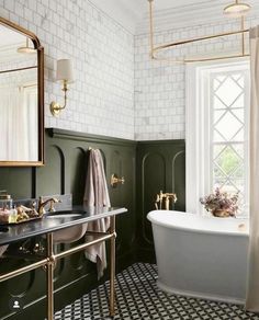 a bath room with a sink and a bath tub next to a window in it