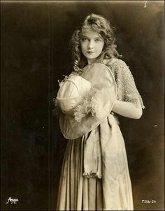 an old black and white photo of a woman