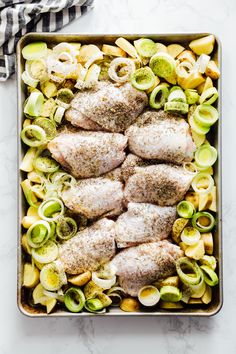 raw chicken and vegetables in a baking dish