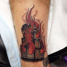 a man with a tattoo on his leg that has a fire coming out of it