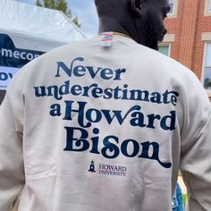 a man wearing a t - shirt that says never underestimate a howard bison