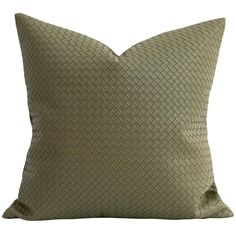 a green pillow with a woven design on the front and back, sitting on a white background