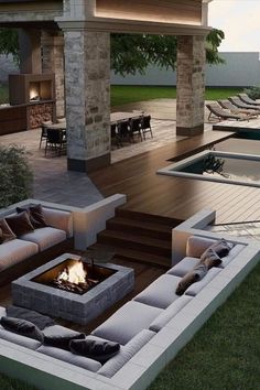 an outdoor living area with couches and fire pit