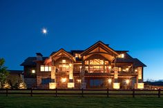 a large house lit up at night in the evening