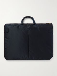 When you use a Porter-Yoshida & Co bag, you can really feel its commitment to making really great accessories. Made from durable and lightweight nylon, this 'Tanker Short Helmet' tote is spacious enough to use as a gym or overnight carryall. It's lined with the signature bright-orange shell. Blue Nylon Bag With Laptop Sleeve, Navy Nylon Bags For On-the-go, Nylon Bags With Laptop Sleeve For On-the-go, On-the-go Nylon Bag With Laptop Sleeve, Modern Nylon Bag With Laptop Sleeve, Luxury Nylon Pouch Bag, Nylon Rectangular Bag With Laptop Sleeve, Nylon Laptop Sleeve Rectangular Bag, Rectangular Nylon Bag With Laptop Sleeve