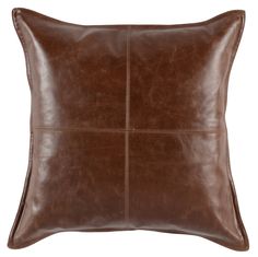 a brown leather pillow on a white background