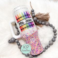 this is a photo of a personalized coffee mug and beaded bracelet on a white fur surface