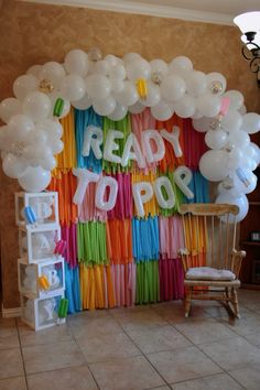 balloons and streamers are arranged on the wall to spell ready to do's