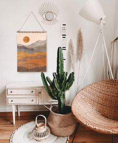 a living room with a wicker chair and potted plant on the floor in front of a white wall