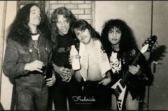 the group of young men are posing together with their guitars