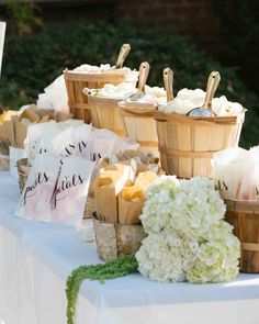 baskets filled with food sitting on top of a table next to flowers and napkins