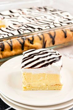 a piece of cake sitting on top of a white plate next to a glass pan