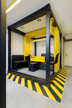 an office with yellow and black stripes on the floor is pictured in this image, it appears to be empty