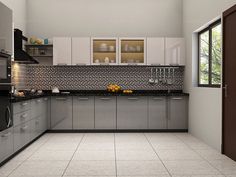 a modern kitchen with stainless steel appliances and tile flooring