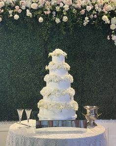 a white wedding cake sitting on top of a table