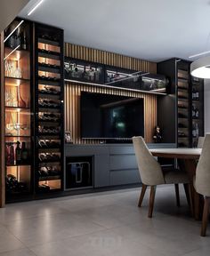 a dining room table and some chairs in front of a large screen tv on the wall