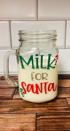 a glass jar filled with milk sitting on top of a wooden table