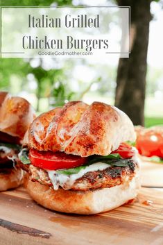 two grilled chicken burgers on a cutting board