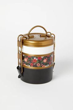 a black and white container with flowers on it