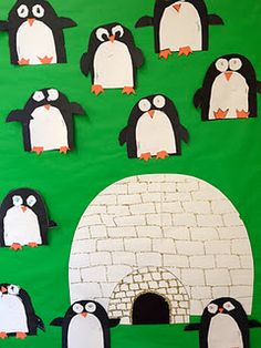 a bulletin board with penguins and an igloose in the middle on it