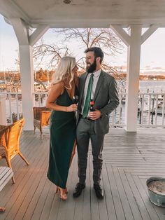 a man and woman standing on a porch next to each other