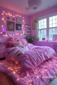 a bedroom decorated in pink and purple with fairy lights