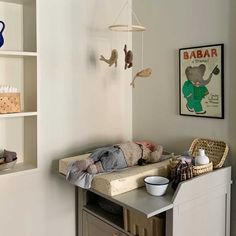 a baby crib in the corner of a room with bookshelves and toys