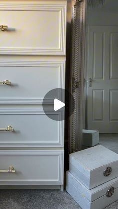 a white dresser sitting next to a bed in a room with carpeted flooring