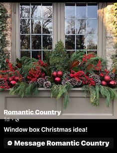 a window box with christmas decorations and greenery in front of a stone building that reads romantic country