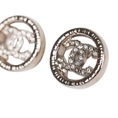 These Chanel stud earrings are in silver tone metal with the signature CC logo design in rhinestones. Origin: FranceCondition: New and never worn Accompanied by: Chanel boxMeasurements: 1" x .5" Luxury Metal Clip-on Earrings, Luxury Silver Metal Clip-on Earrings, Designer Round Silver Earrings, Designer Silver Round Earrings, Luxury Silver Clip-on Earrings For Evening, Designer Silver Clip-on Earrings, Designer Silver Earrings For Anniversary, Designer Silver Earrings With Diamond Accents, Luxury Silver Bling Earrings