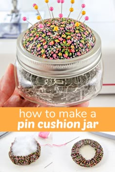 a jar filled with sprinkles and pins sitting on top of a table