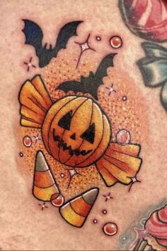 a close up of a person's stomach with tattoos on it and an image of a pumpkin