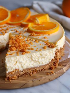 there is a cake with oranges on the top and one slice missing from it