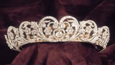 a tiara is displayed on a velvet cloth