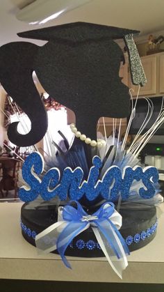 a graduation cap with the word seniors on it and some decorations in front of it