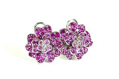 These wonderful pierced earrings feature a floral design and are each accented with 11, bead sets of round brilliant cut natural pink sapphires, and 2 round brilliant cut diamonds in the center.  The earrings measure 16.5mm X 16.5mm and are finished with omega-style backs. Vintage but like new! total weight earrings 7.9gram Sapphire 1.5 ctw approx #0024