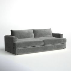 a gray couch sitting on top of a white floor