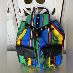 Elevate Your Fashion Game With This Stunning Versace Retro Striped Colorful Backpack Bag! This Beautiful Bag Boasts A Stylish Striped Pattern In Vibrant, Eye-Catching Colors That Are Sure To Turn Heads Wherever You Go. Made From High-Quality Canvas And Leather Materials, This Backpack Is Both Durable And Fashionable, Perfect For Any Occasion. Featuring A Drawstring Closure And Black Leather Handles/Straps With Gold Hardware Accents, This Backpack Is Both Functional And Fashionable. The Interior Is Lined With Luxurious Black Leather And Features A Brand Card For Authenticity. With Its Vintage Style And Colorful Design, This Versace Backpack Is A Must-Have For Any Fashion-Forward Woman. Ov Versace Backpack, Brand Card, Colorful Backpacks, Bag Fabric, Backpack Bag, Colorful Design, Leather Handles, Eye Catching Colors, Beautiful Bags