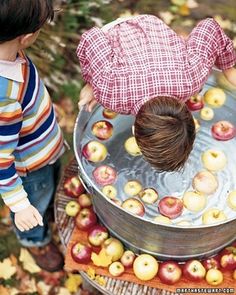 two children are playing in an apple pool