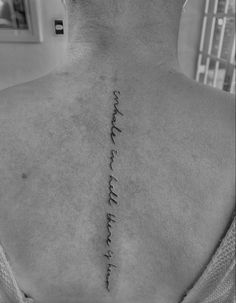 the back of a man's neck with words written in cursive writing