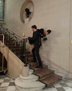 two people in formal attire climbing the stairs