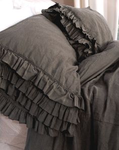 an unmade bed with ruffled sheets and pillows