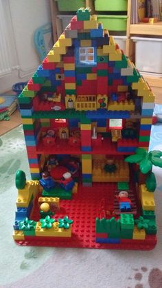 a toy house made out of legos on the floor