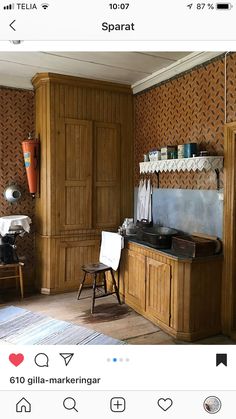 an old fashioned kitchen with wood paneling and wooden cabinets in the corner, on instagram