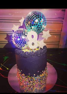 a birthday cake decorated with disco balls and stars