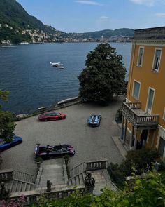 three cars parked in front of a house on the water