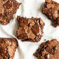 brownies with chocolate frosting are on a piece of parchment paper