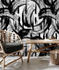 a black and white abstract wallpaper with wicker chairs in front of the table