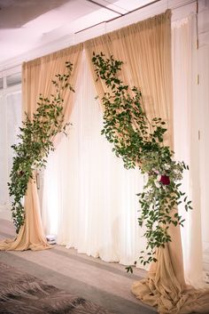 an image of a wedding ceremony setting with flowers and greenery on the side of the stage